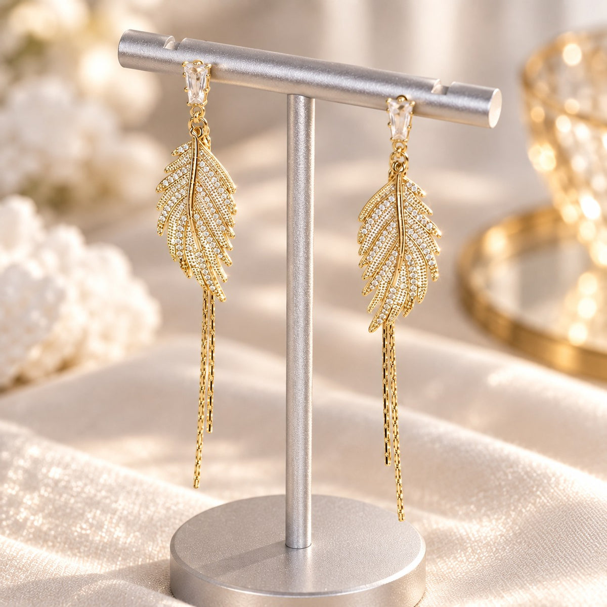 Gold leaf tassel earrings hanging on display