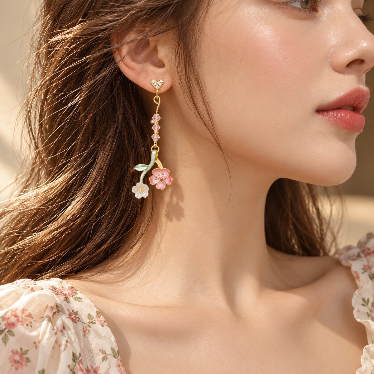 Model wearing asymmetrical pink flower earring with pink crystal beads