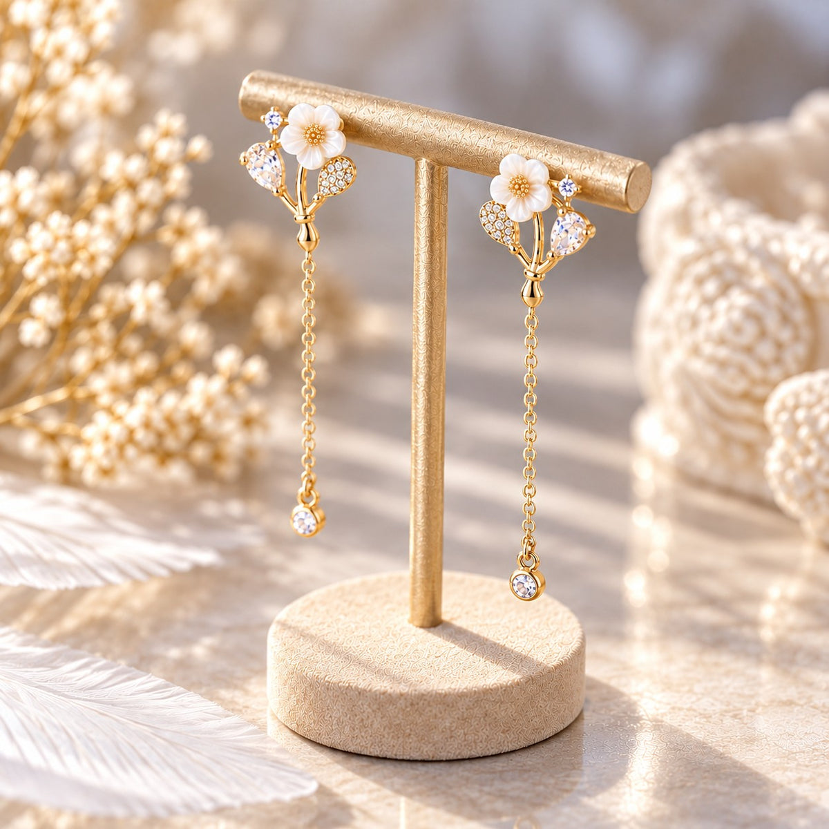 Gold flower crystal stud dangle earrings on jewelry stand