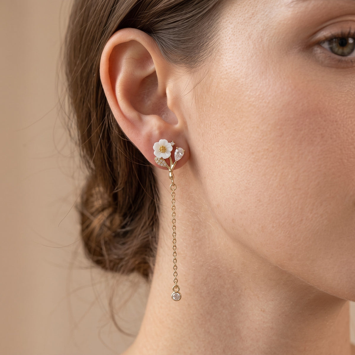 Side view of model wearing gold flower chain earring