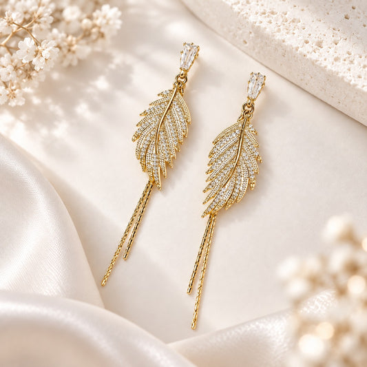 Gold leaf CZ drop earrings on ivory satin