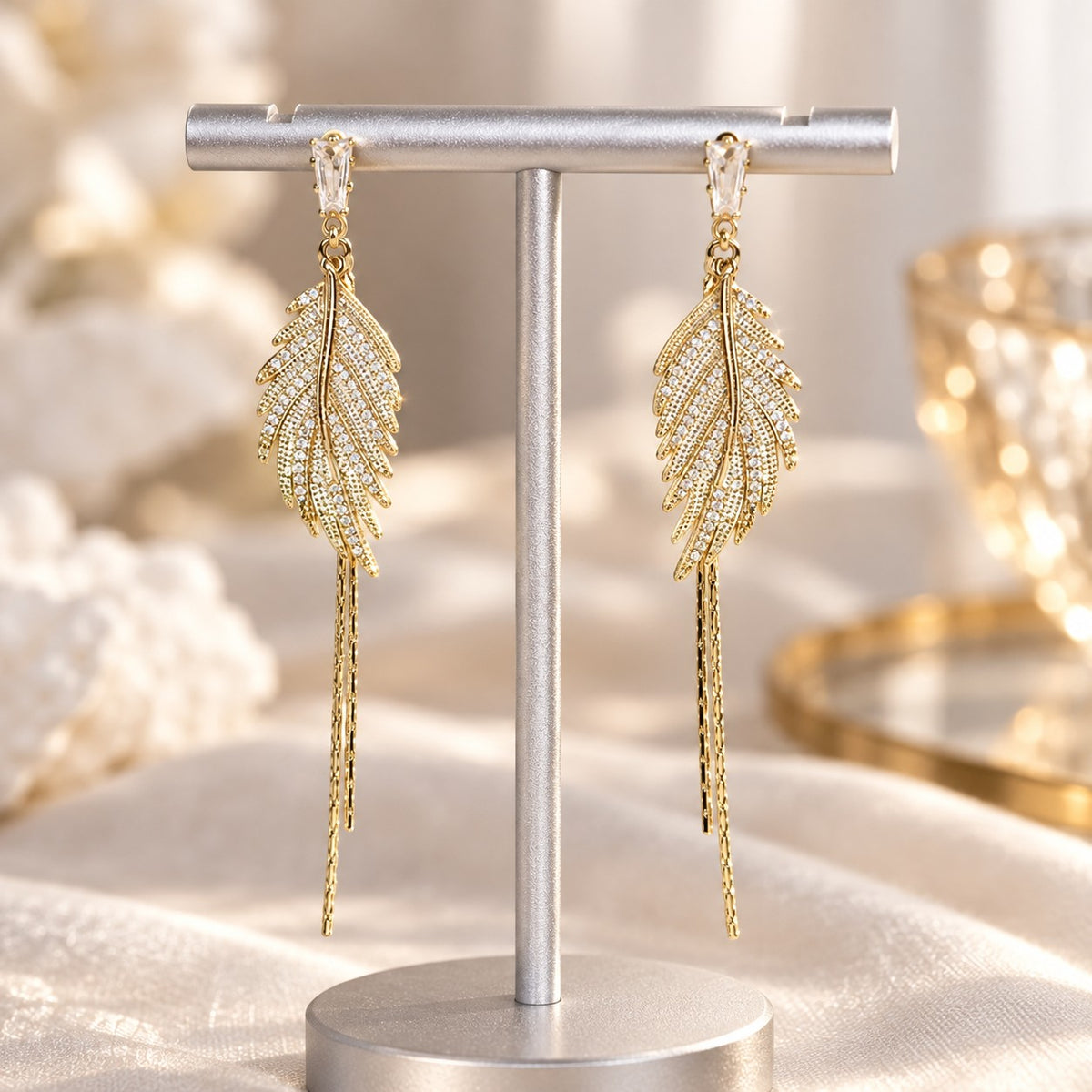 Gold leaf crystal earrings on elegant display stand