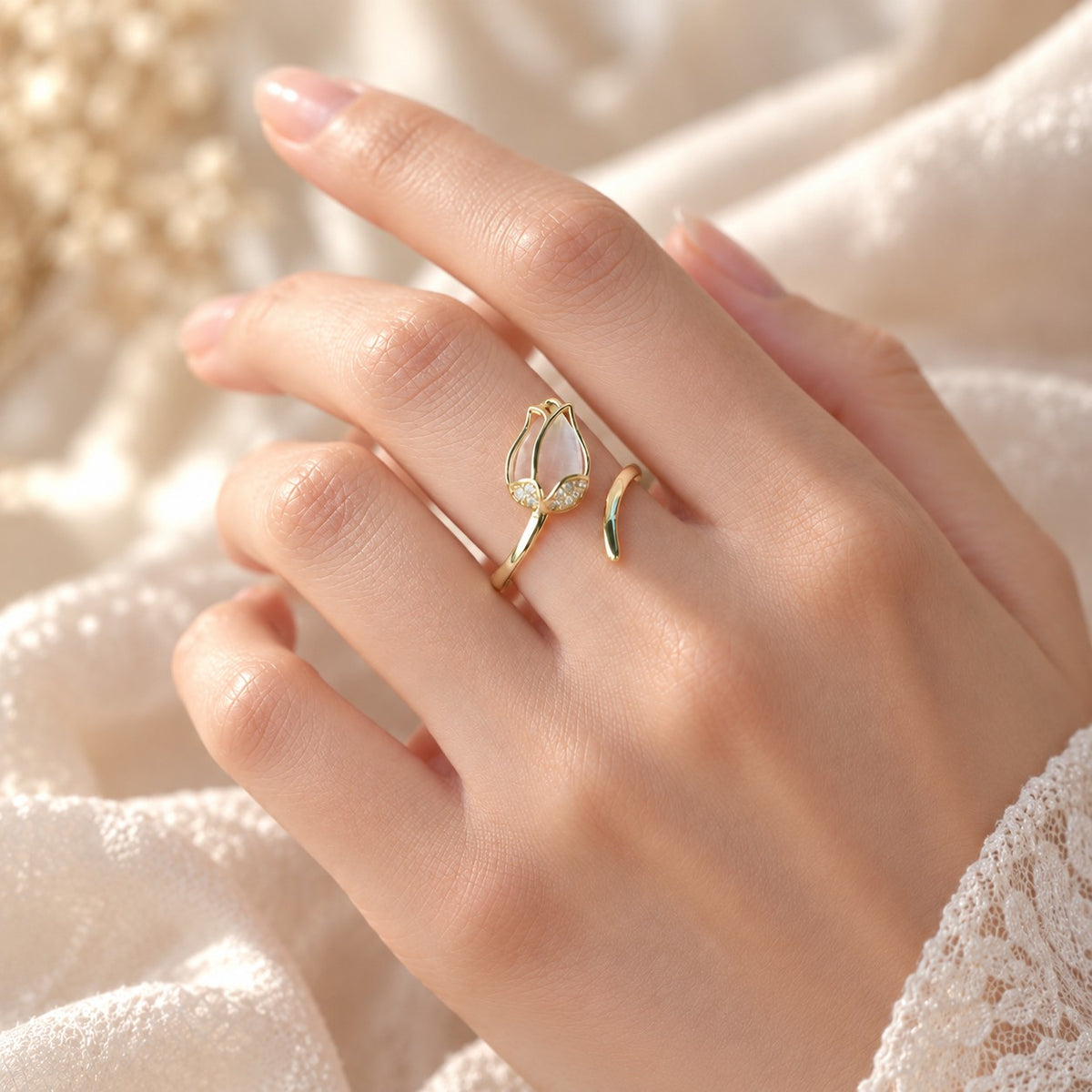 Woman's hand wearing adjustable gold tulip ring