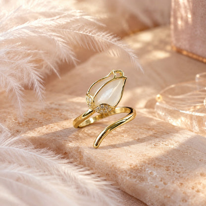 Gold opalescent tulip ring with crystals in soft light