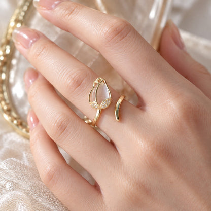 Close-up of white tulip gold ring on hand