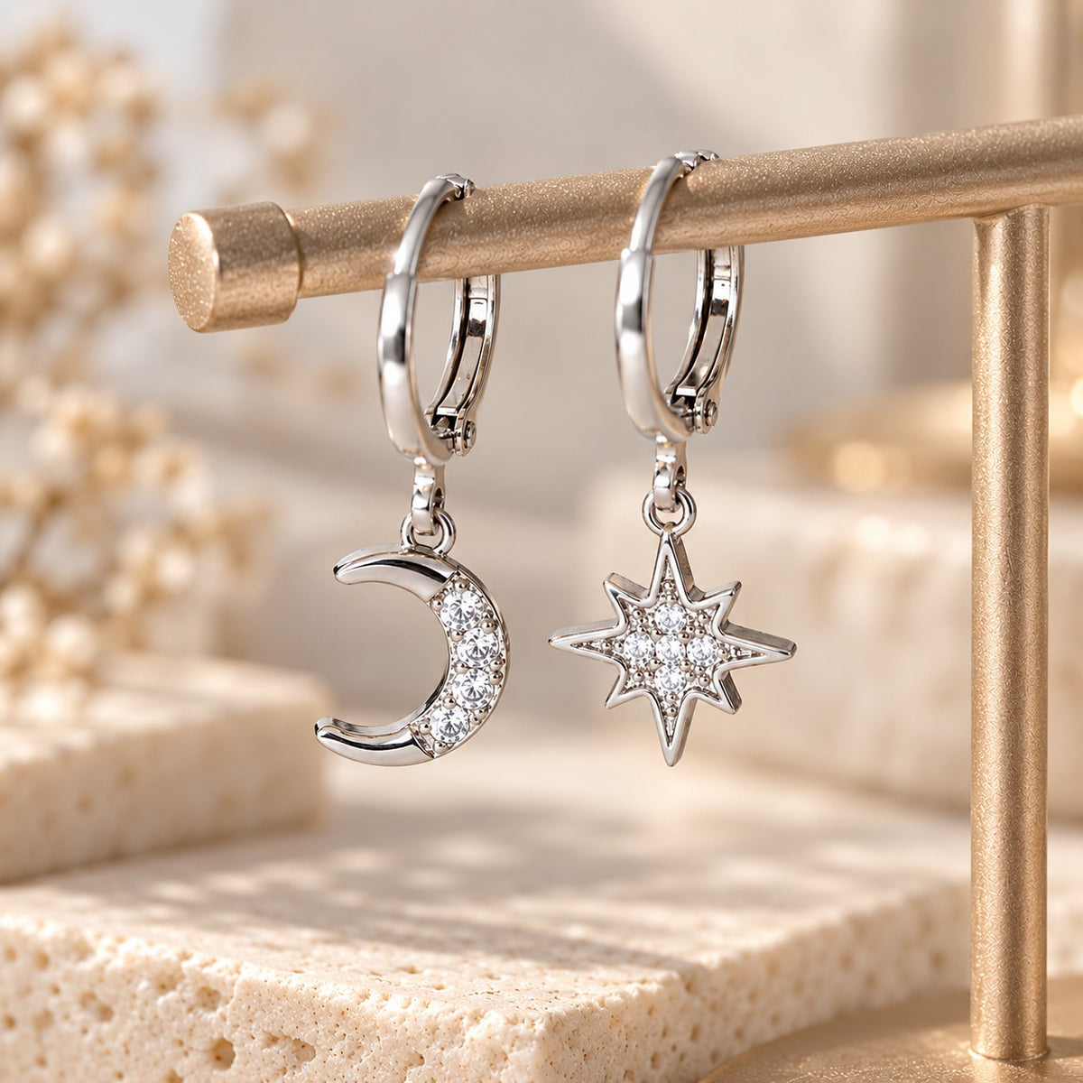 Silver crescent moon and north star huggie hoops on display