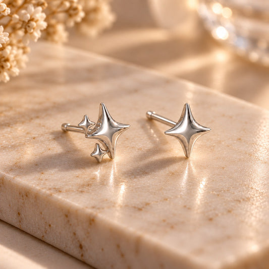 Silver sparkle star stud earrings on marble